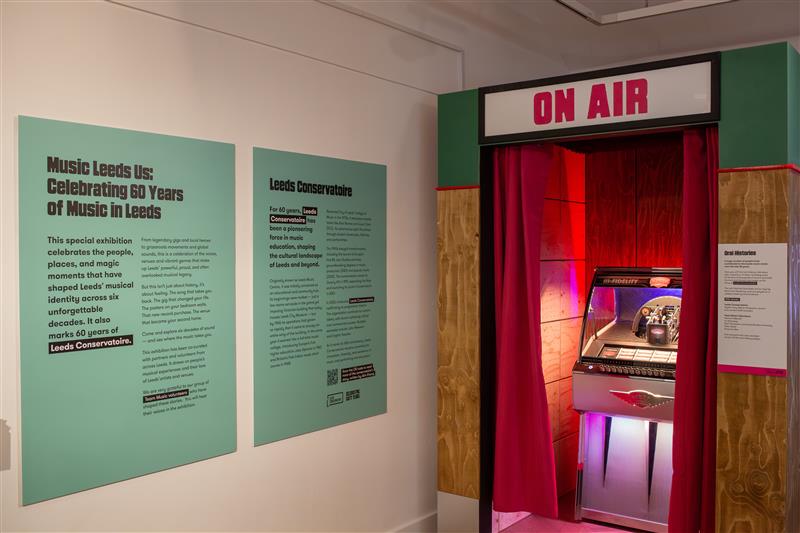 A dute box and signs for Music Leeds Us