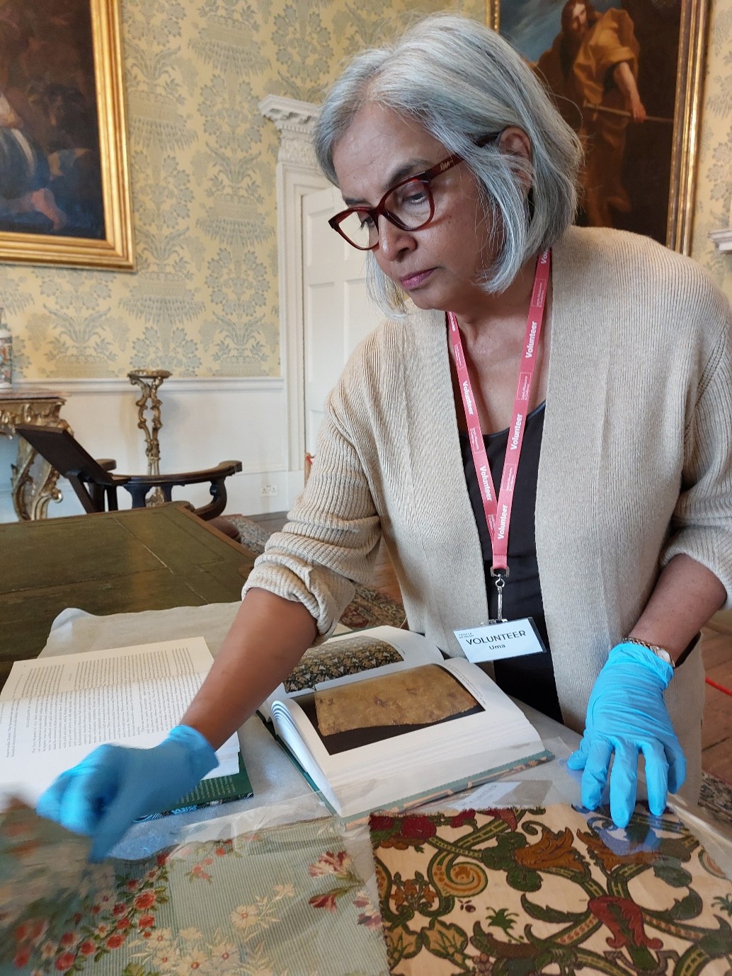 A volunteer looking at textile samples from the collection