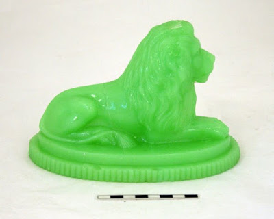 Victorian lion glass paperweight. It is fluorescent green