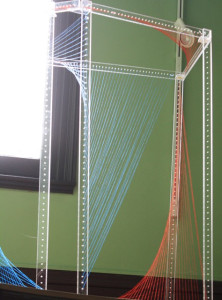 A metal frame with coloured lines crossing through it.