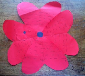 A handmade poppy with a poem written inside.