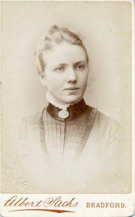 A black and white head shot of a young Victorian woman. The bottom of the image says 'Albert Sachs, Bradford'.