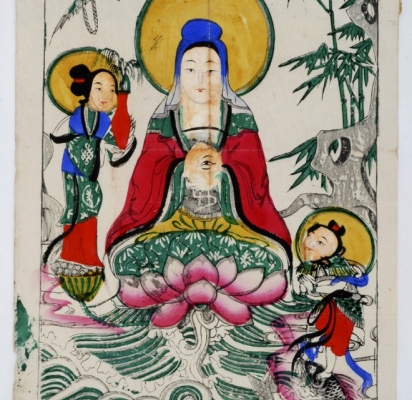 A woodblock printed with a colourful image of a goddess sitting on a lotus flower, with children gazing up at her.