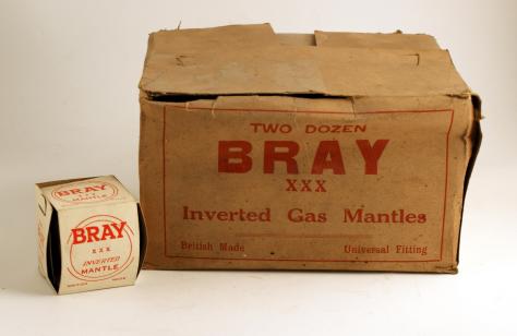 an image of an old cardboard box with "Two dozen Bray xxx inverted gas mantles" printed in red. Next to it is a small inverted mantle.