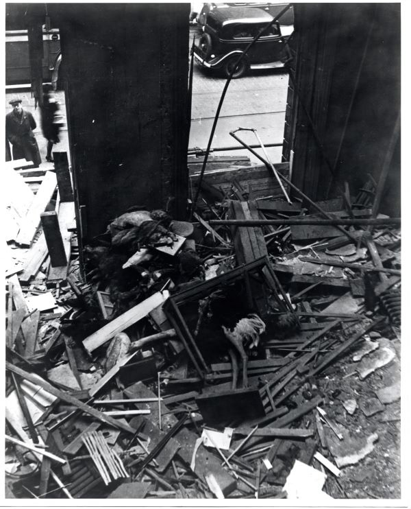 a black and white photograph of rubble where the bomb has caused destruction.