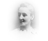 a black and white photograph of a woman's face. Her hair is tied up and she is wearing a white dress.