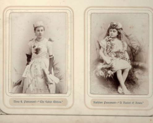 2 black and white photographs of young girls dressed in costume. Nora's dress is made of newspaper and has black gloves and a paper hat, and Kathleen is adorned in flowers.