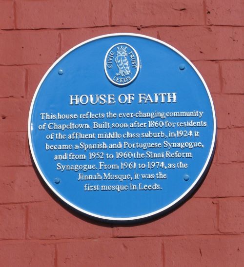 a blue plaque on a brick wall. It says 'House of Faith - this house reflects the ever changing community of Chapeltown. Built soon after 1860 for residents of the affluent middle class suburb, in 1924 it became a Spanish and Portugese Synagogue, and from 1952 to 1960 the Sinai Reform Synagogue. From 1961 to 1974, as the Jinnah Mosque, it was the first mosque in Leeds.