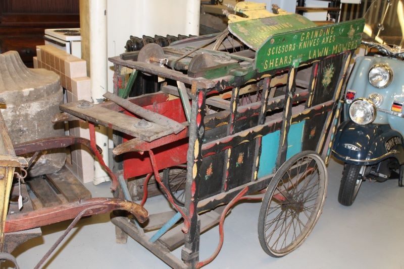 A modern day photograph of an old cart. It's very colourful but oviously very old.