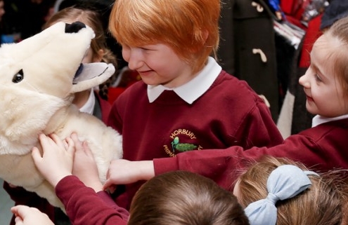Schoolchildren with an animal puppet