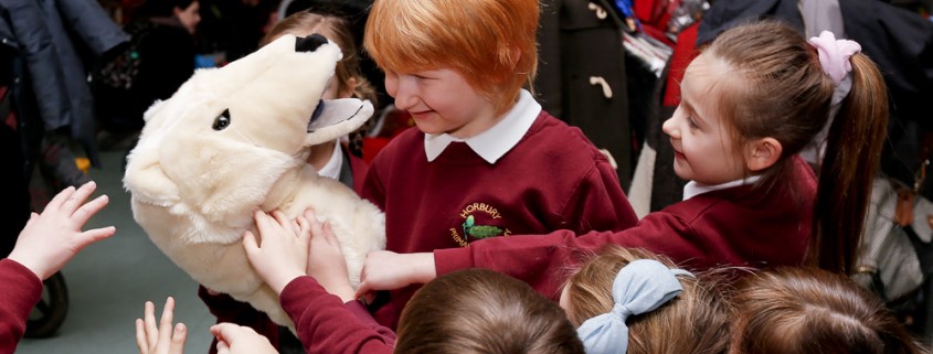 Schoolchildren with an animal puppet