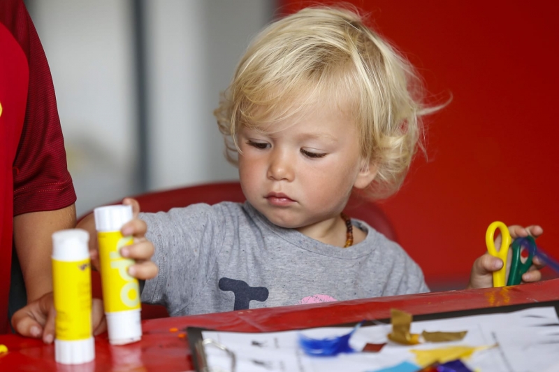 A young boy doing messy crafts at Tiny Tigers