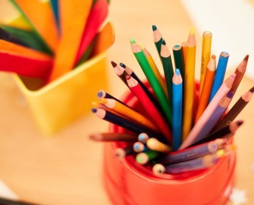 Coloured pencils and other craft materials set-up for school activities