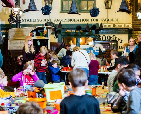 People taking part in Halloween crafts in the Victorian Streets at Abbey House Museum