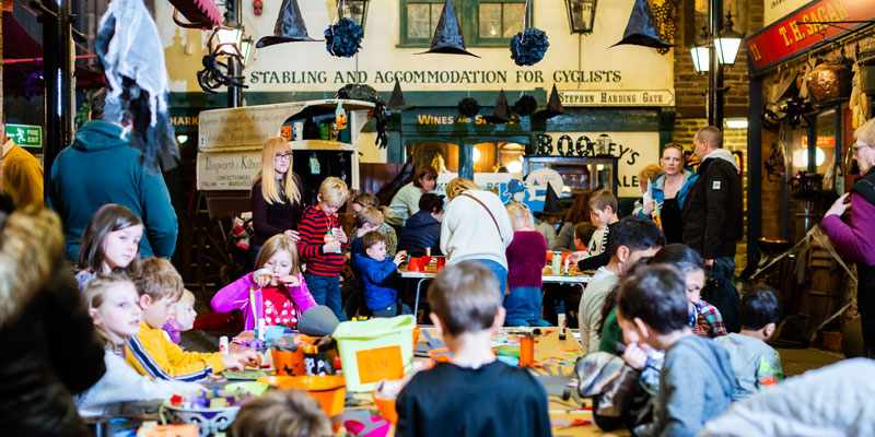People taking part in Halloween crafts in the Victorian Streets at Abbey House Museum