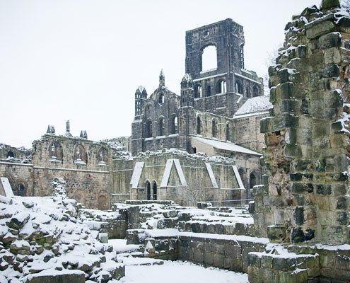 Kirkstall Abbey ruins covered in snow