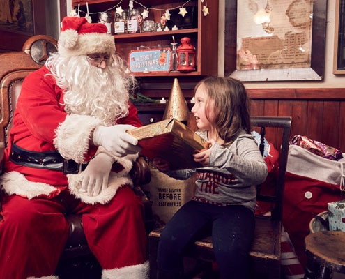 Santa and a young girl at the Abbey House Museum grotto