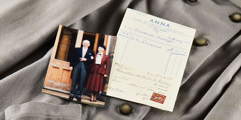 a suit jacket with a photograph of a woman and a handwritten note.
