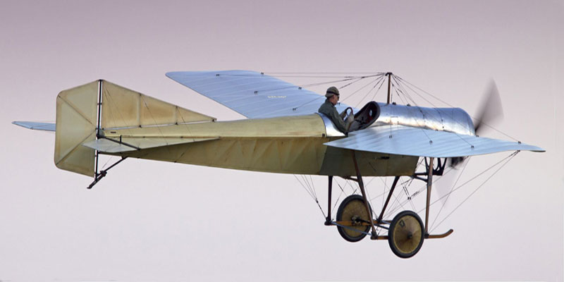 A blue and cream coloured model plane with a toy pilot