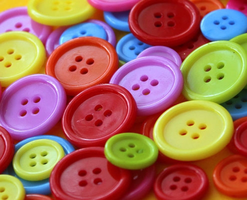 A pile of assorted coloured buttons