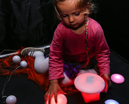A young girl playing with tactile toys