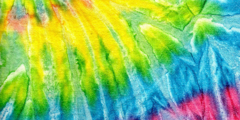 tie dye colours on fabric including yellow, green, blue and pink