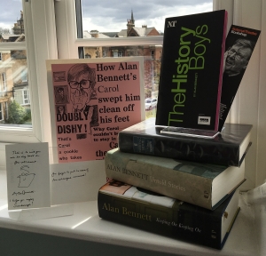 A windowsill with lots of books by Alan Bennett.