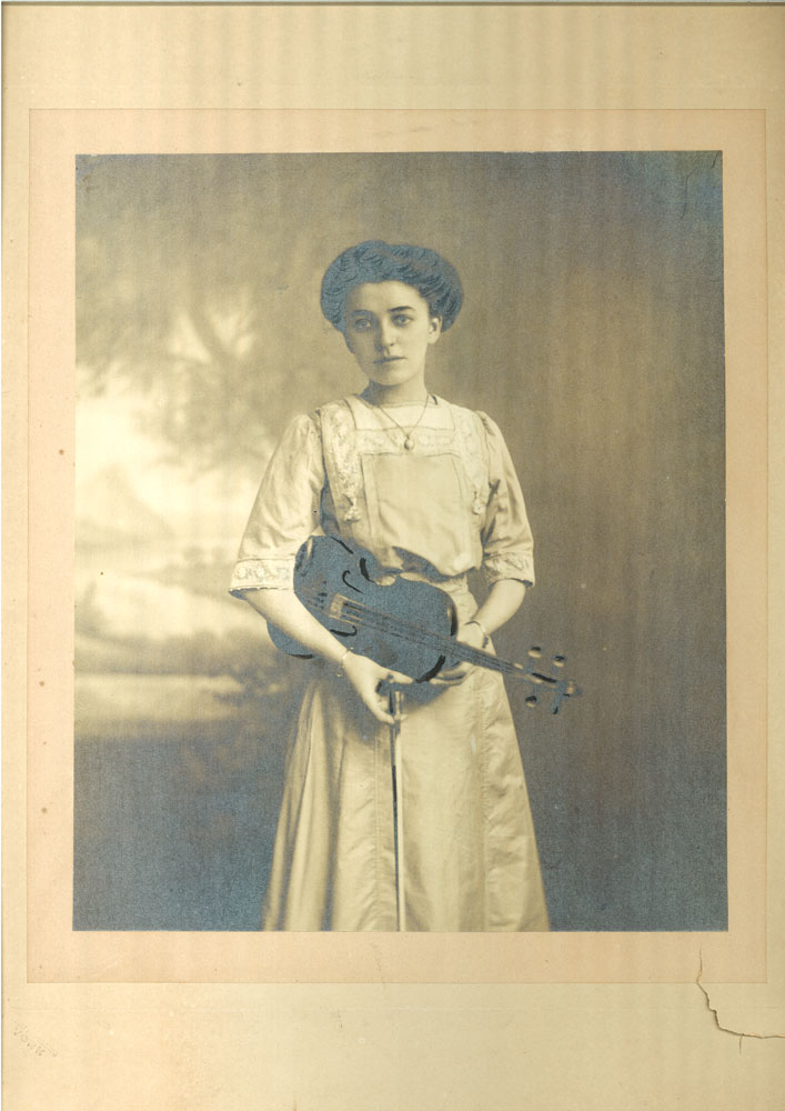 Old photo of a woman holding a violin