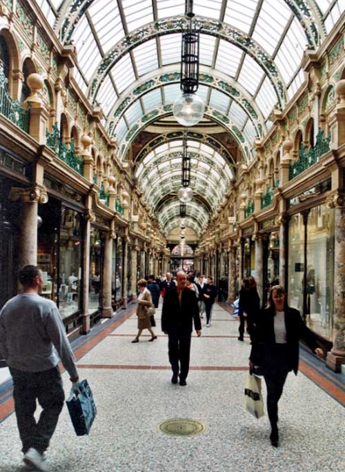 The interior of the Victoria Quarter shopping arcade in Leeds with shoppers walking through
