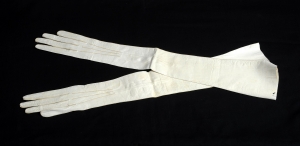 A very long pair of well worn white gloves.