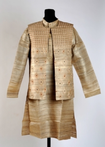 A mannequin is wearing a waistcoat and long collarless tunic in a shimmery beige colour
