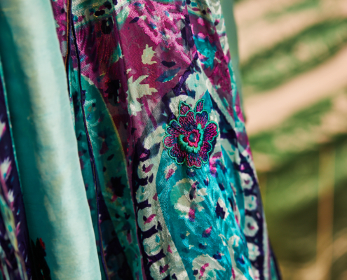 A close up of a blue, purple and turquoise salwar kameez