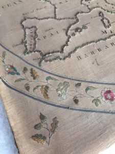 A close up of an embroidered map