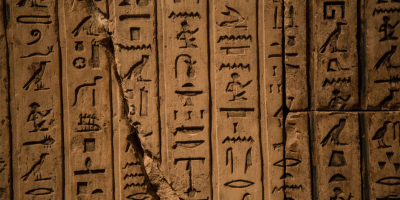 Hieroglyphs on a stone with a crack down the middle