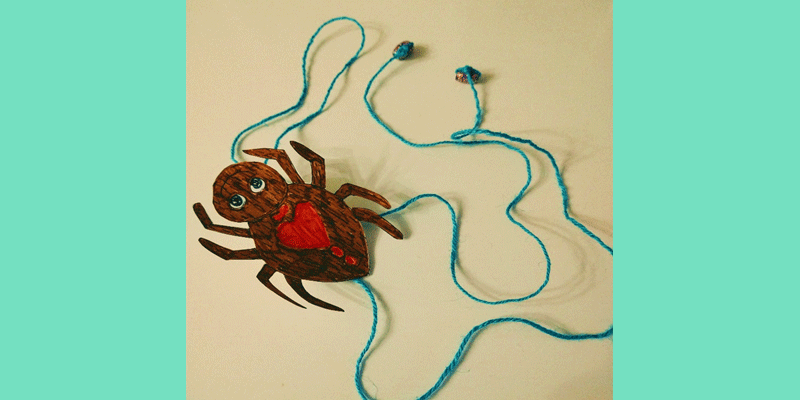 A spider made from paper with string