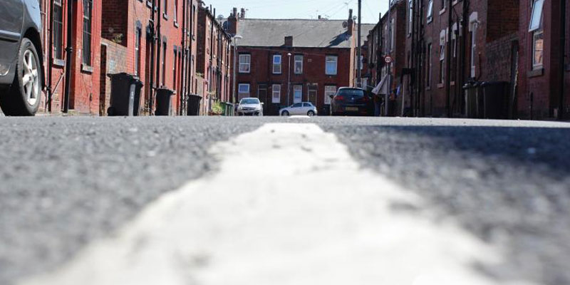 A photograph of a road on a street of terraced houses in Leeds
