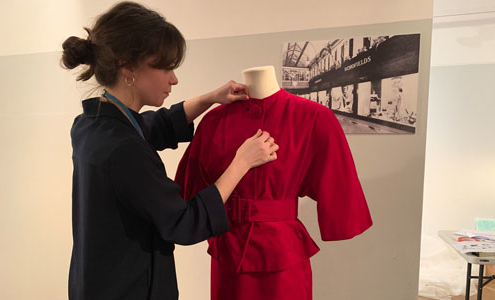 Assistant curator of Textiles and costume makes final tweaks to an outfit on display at Leeds City Museum
