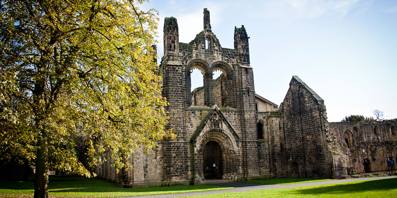 Exterior view of Kirkstall Abbey in autumn