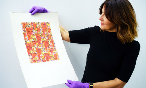 A woman holds a Sheila Bownas print