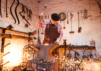A blacksmith at work in his workshop