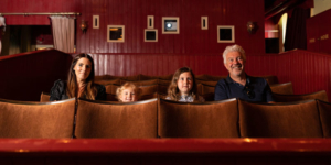 A family are sat in the Palace Picture House of Armley Mills