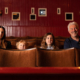 A family are sat in the Palace Picture House of Armley Mills