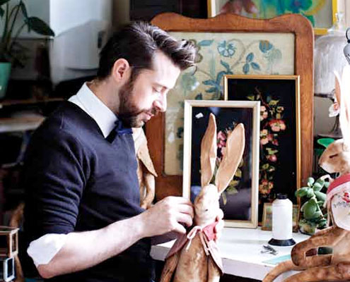 Mister Finch in his workshop with a textile rabbit.