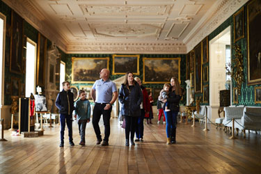 A family walk through the Picture Gallery inside Temple Newsam House
