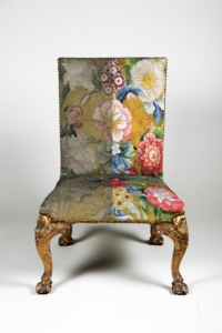 An embroidered chair, showing how one half has been recoloured digitally and how the other half has faded.