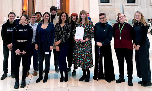 Leeds City Museum's Preservative Party holding a certificate for their Marsh Award for volunteering.