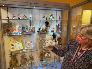 Curator of Leeds Social History holding a Care Bear Toy