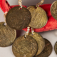 coins attached to a red ribbon