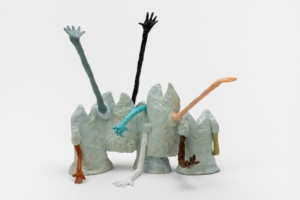 A clay sculpture of grey torsos attached to each other, and different coloured hands coming out of the sleeves