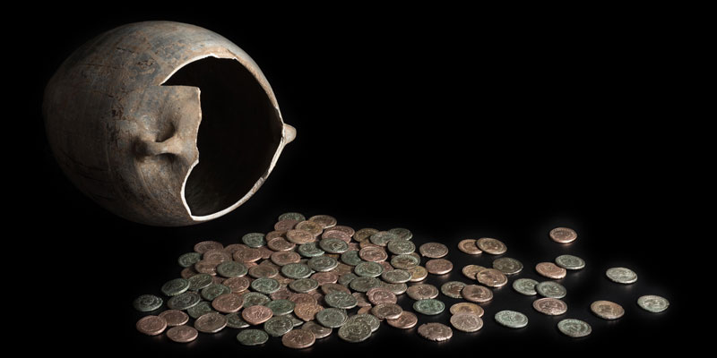 A vessel and coins from a money hoard. Image courtesy Yorkshire Museums.